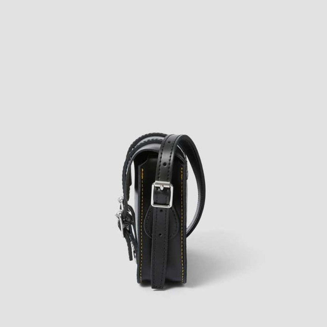 Dr Martens Leather Cross Body Satchel in classic black, with sturdy sole, secure silver buckle closure, and signature yellow stitching. ksnz, 190665191974