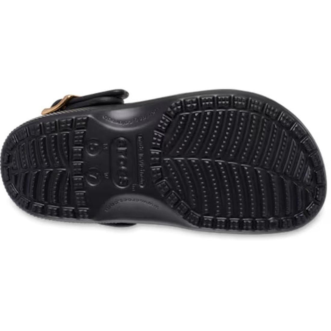 The image features the black rubber sole of the Crocs Womens Classic Metallic Buckle Clog, showcasing its textured, non-slip tread pattern and an adjustable backstrap with a metallic buckle for secure fit., 53868, 198445480461, 198445480478, 198445480485,