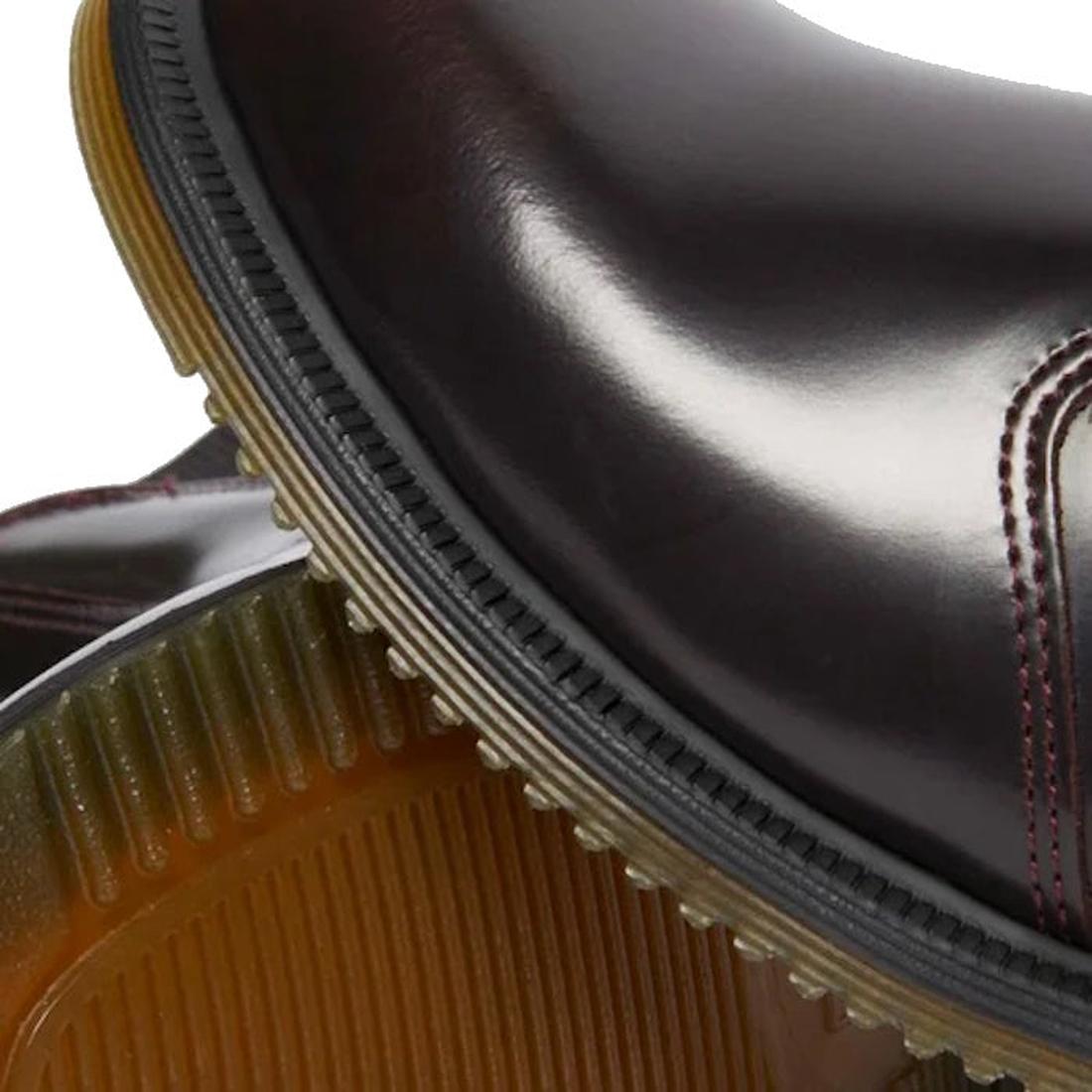 Close-up of the toe showing red stitching detail of a Dr Martens Flora Red boot and a slight view of the sole on the other foot leather shoe with a white background.,
190665698268,
190665698275,
190665698282,
190665698305,
190665698312,
190665698329,, 190