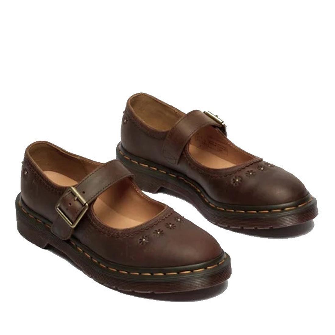A pair of Dr Martens Mary Jane Flower Dark Brown Crazy Horse shoes featuring a buckle strap, thick soles, and decorative floral cutouts on the front and sides., 52079, 190665785531, 190665785548, 190665785555, 190665785579, 190665785586, 190665785593