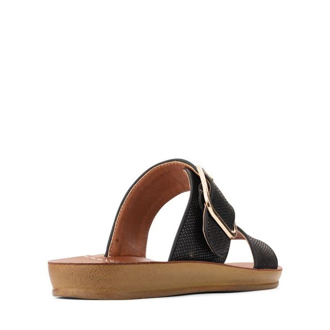 The Los Cabos Doti Black Raffia Light Flexible-Sandal is a women's slip-on with a textured strap, gold buckle, open toe, flat brown sole, and stylish summer design. Shown angled on a white background., 9321191299525, 9321191299532, 9321191299549, 93211912
