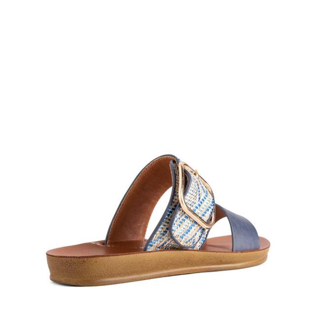 The Los Cabos Doti Navy Multi Light Flexible Sandal is a women's slip-on with a tan sole, blue strap, plus a textured blue-and-white strap with a large gold buckle. Designed for comfort and gentle arch support, it's pictured angled to show the back and si