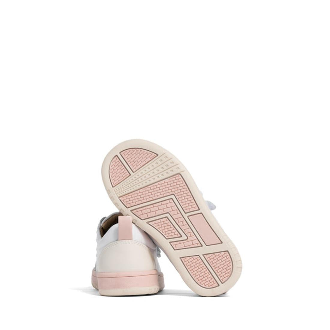 A pair of Pretty Brave Happy Trainer White/Blush kids sneakers with pink soles—one upright and the other on its side showing the textured pink outsole—are set against a plain white background., 40192, 9420075335905, 9420075335899, 9420075335882, 942007533