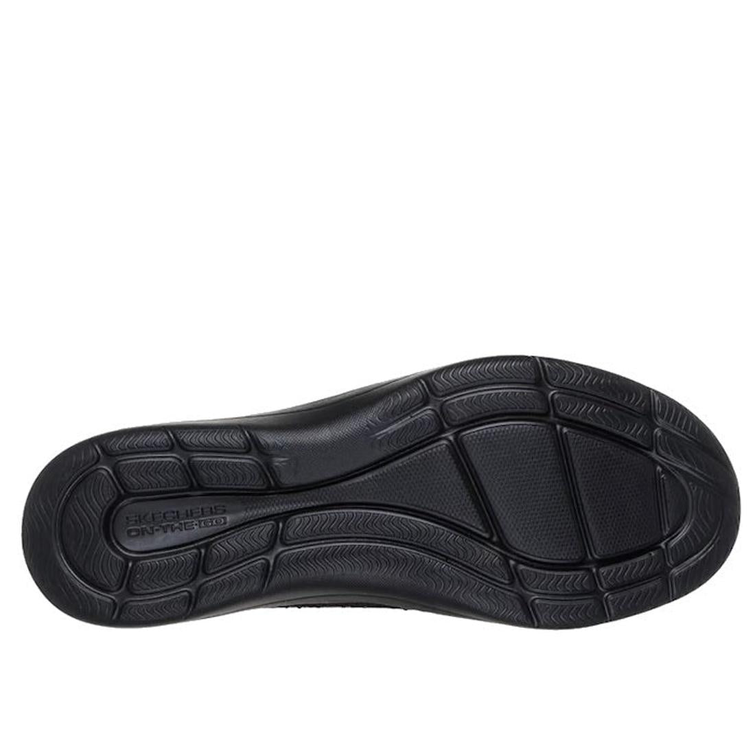 The image displays the black rubber sole of the Skechers Slip In On The Go Flex Radiant Dazzled Black, featuring a textured tread pattern and "Skechers On The Go" embossed near the heel, which pairs beautifully with its rhinestone-embellished knit upper f