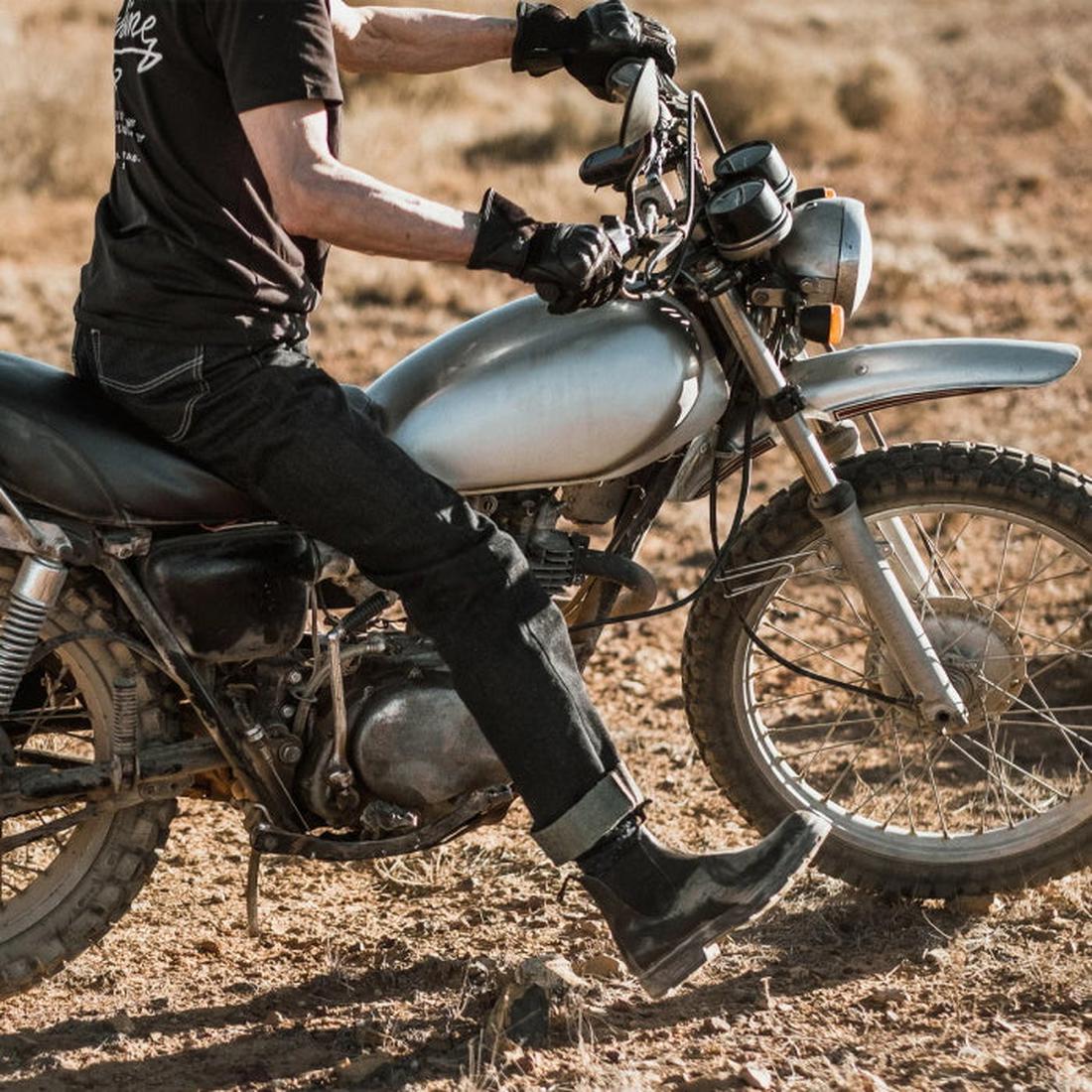 A person in black clothing, gloves, and Blundstone 063 Dress Chelsea Boots sits on a silver motorcycle parked on dry, rocky terrain under bright sunlight., 27603, 9315891155977, 9315891155991, 9315891156011, 9315891156035, 9315891156059, 9315891156073, 93