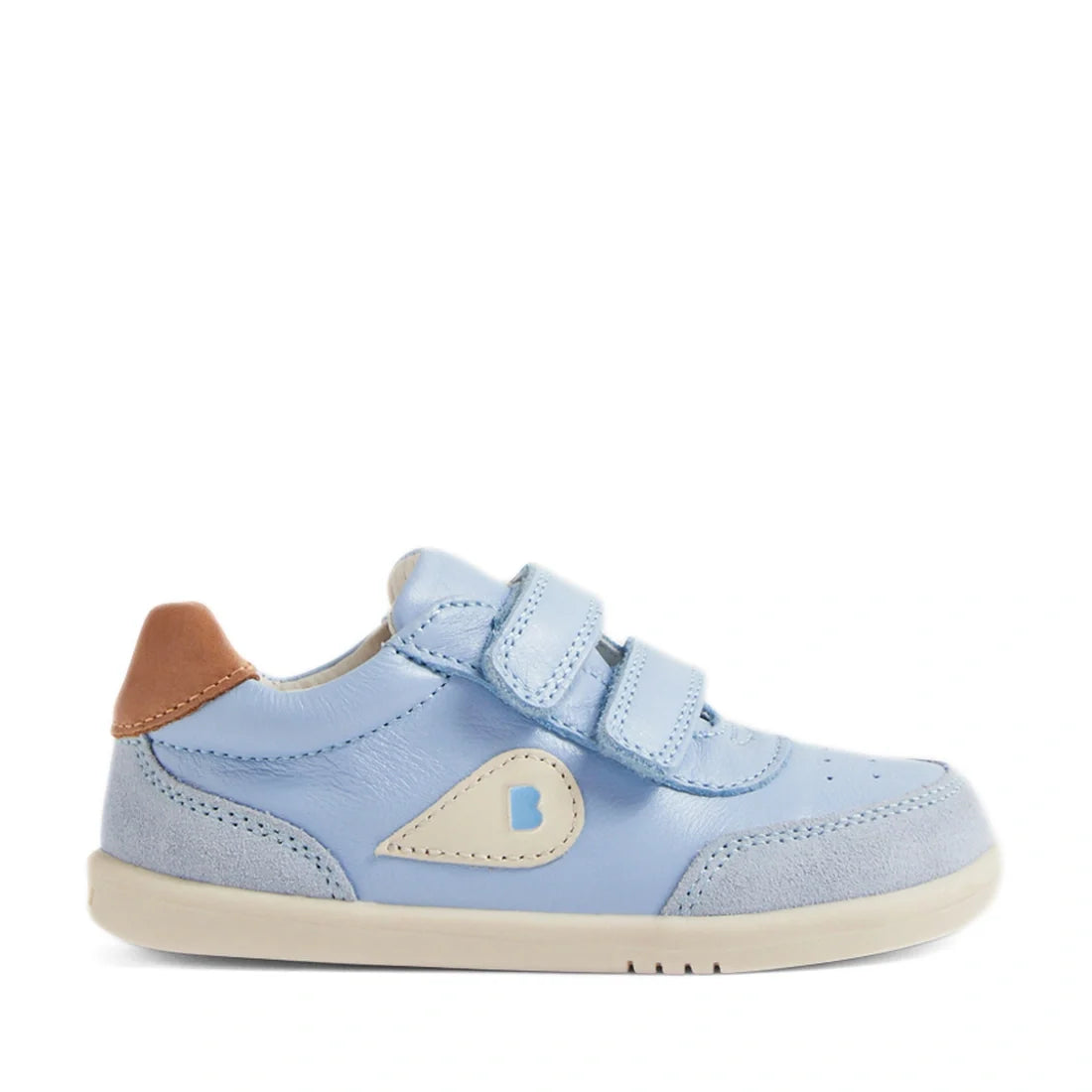 The Bobux IW Iwalk Toddlers Champ Leather Sneaker in Skyway Blue features a light blue design with two hook-and-loop straps, beige and brown accents, and a white sole. A small B logo adorns the side, while suede detailing near the toe and heel adds style