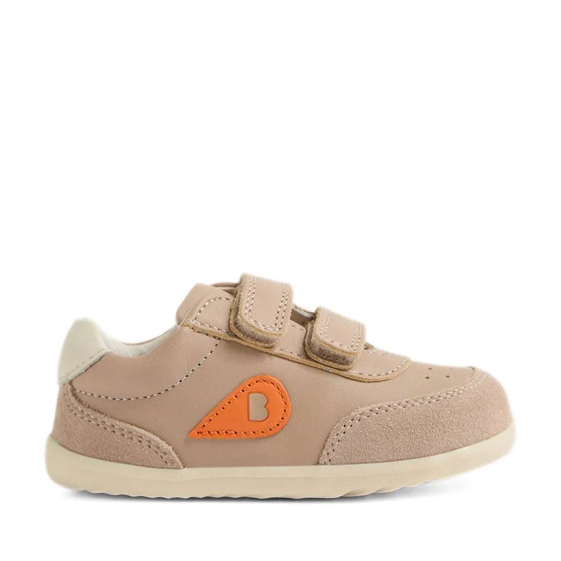 The Bobux Step Up SU Champ Sneaker First Walker in Warm Taupe is a beige toddler shoe featuring two hook-and-loop straps, suede accents, an orange teardrop with a “B” on the side, and a white sole—an ideal stylish first walker sneaker for little ones, sho