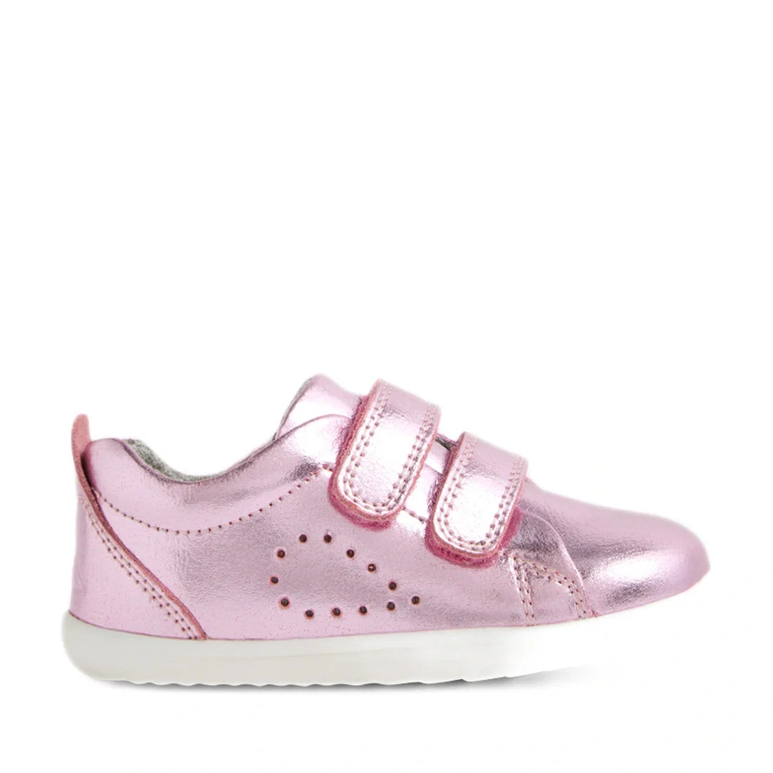 The Bobux Step Up Grass Court Trainer Pink Metallic is a shiny pink toddler shoe inspired by the classic Grass Court design, featuring two hook-and-loop straps, small decorative side perforations, and a white rubber sole—perfect first walkers for little o