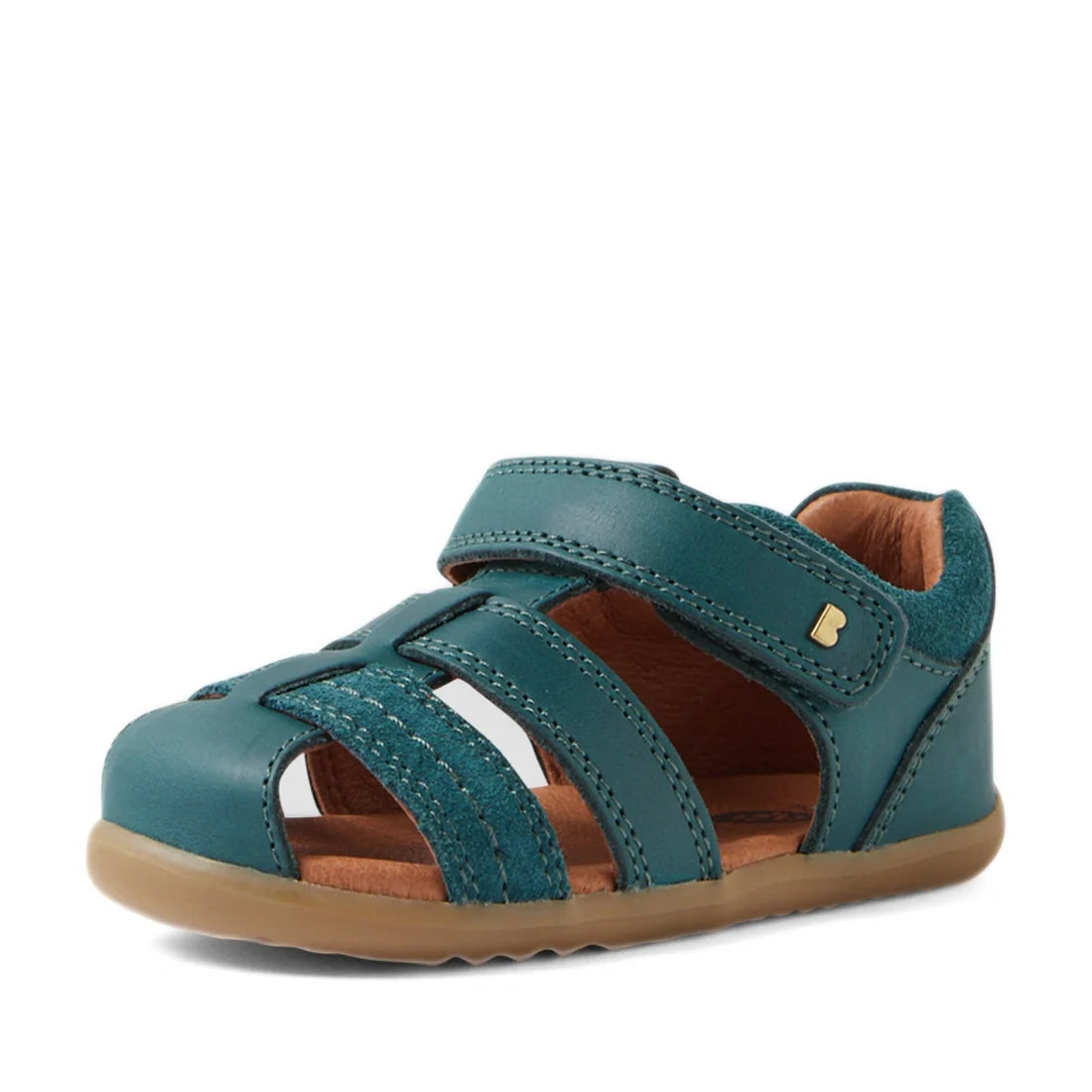 Introducing the Bobux Step Up Sandal Roam Closed Toe Sandals in Mediterranean Green—a leather sandal for children inspired by the classic Roam Toddlers design, featuring a closed toe, adjustable Velcro strap, open sides, tan interior, and a light brown ru