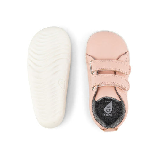 The Bobux Step Up SU Grass Court Trainer 728909J in Seashell Pink is a pair of toddler leather sneakers with white soles, two adjustable hook-and-loop straps, and a soft, flexible design for first walkers. Shown from top and bottom views., 9420075792913,