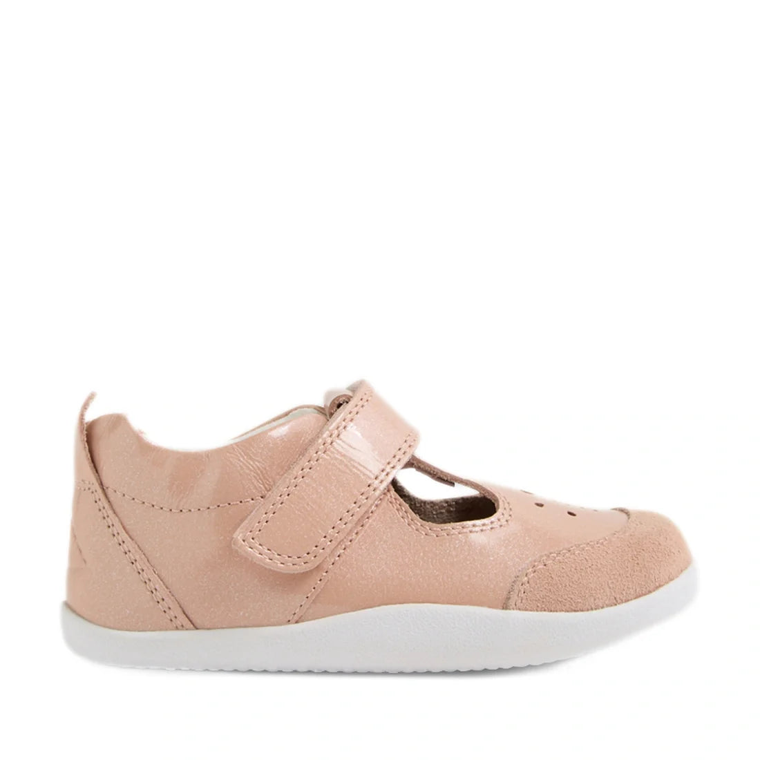 Introducing the Bobux XP Explorer Rue First Walker Sandal in Camo Rose Pink—a light pink toddler shoe crafted from premium materials. These closed-toe T-bar sandals feature a flexible white sole, velcro strap for easy fastening, and a small cutout on top