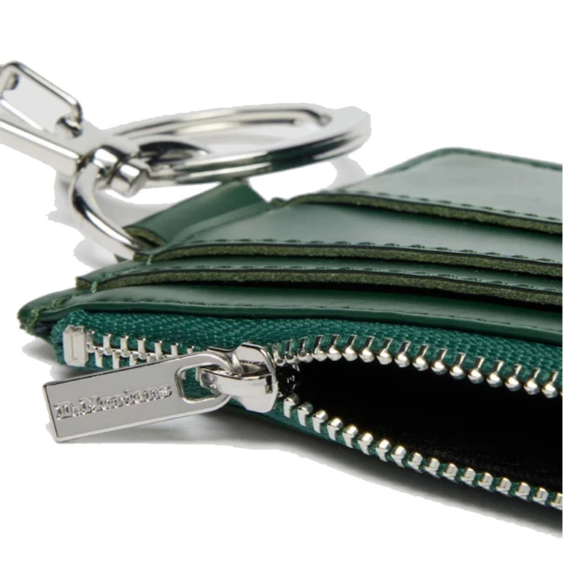Close-up of the Dr Martens Cardholder Keyring Green Kiev Leather Bag Charm. The partially open zippered compartment reveals the interior, showcasing its practical design as a secure coin holder with an attached keyring.