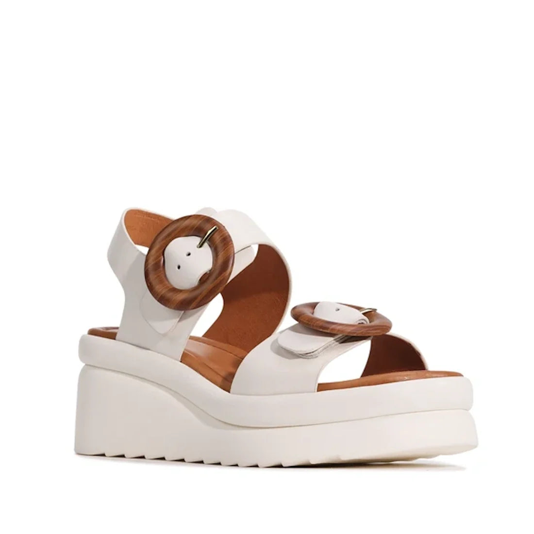 Introducing the EOS Menorcas Bone Leather Women’s Wedge Leather Sandal—crafted from hand-burnished bone leather, this stylish platform sandal features a brown cushioned anatomical footbed, a chunky sole, and two wide straps adorned with statement round br