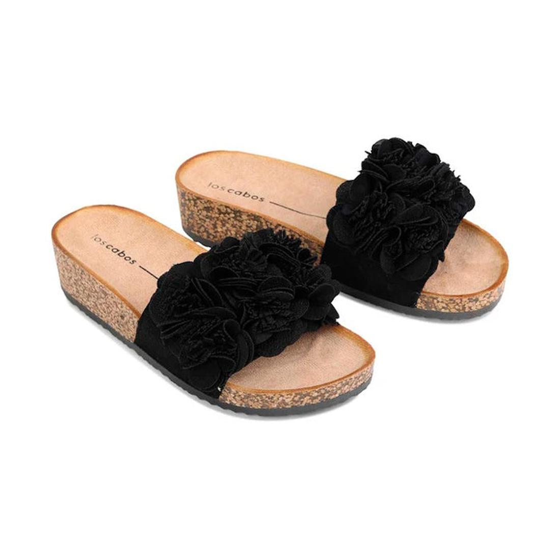 The Los Cabos Corsage Black Flower Women's Slides feature wedge heels with cork soles, beige footbeds printed with the Los Cabos brand, and black fabric straps decorated with layered floral embellishments., 9321191212517, 9321191212524, 9321191212531, 932