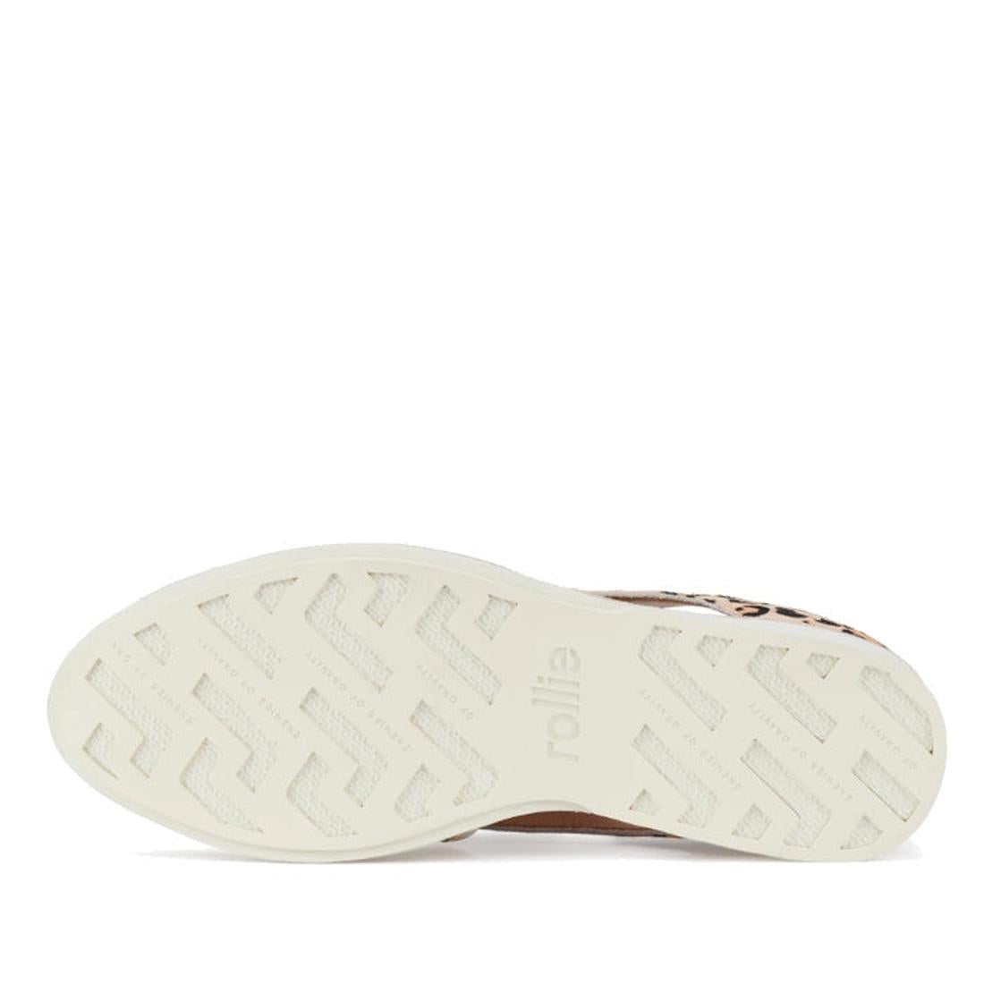 The image shows the white, textured sole of the Rollie Womens Sidecut Punch Bone Leather Leopard Cut Out Brogue shoe, with "rollie" embossed in the center. Zigzag tread lines offer traction and breathable linings deliver comfort with each step., 933955430