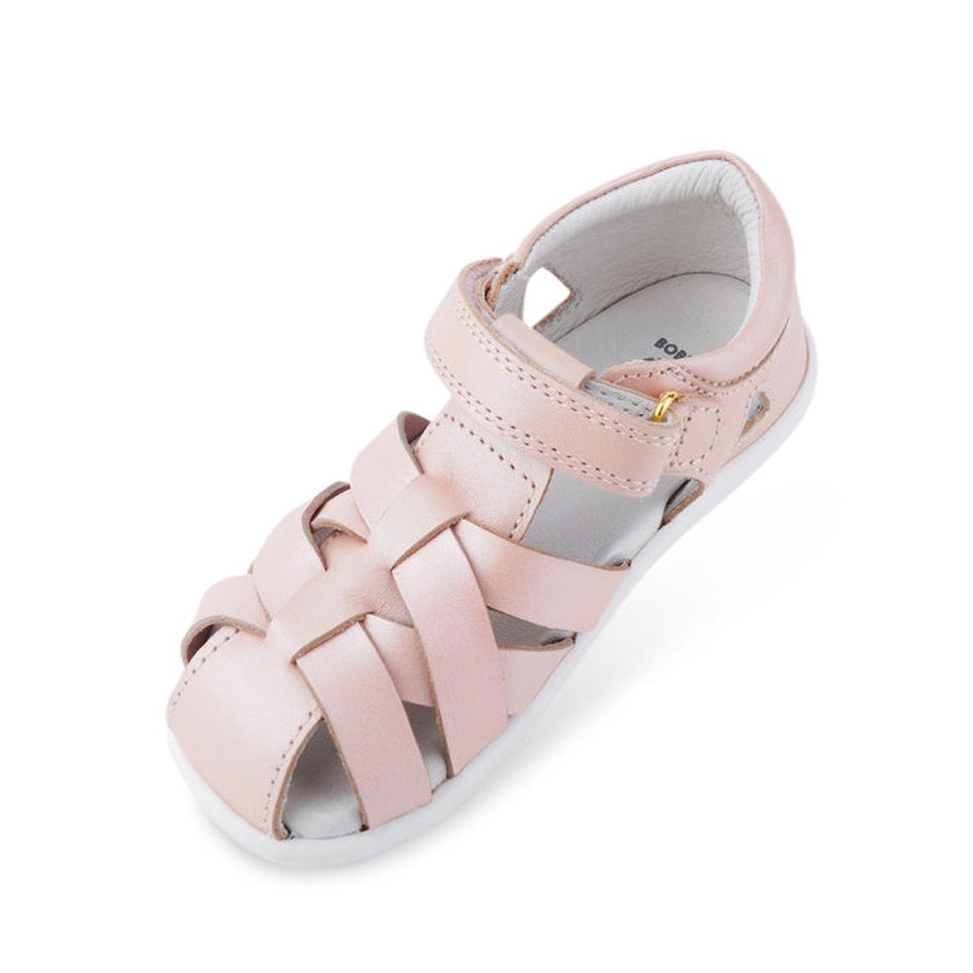 The Bobux Iwalk IW Tropicana II Sandal 638305 in Seashell Pink is a kids' sandal with closed toe, quick-dry leather woven straps, hook-and-loop ankle closure, and a white sole—ideal stylish summer footwear against a white background., 9420068504356, 94200