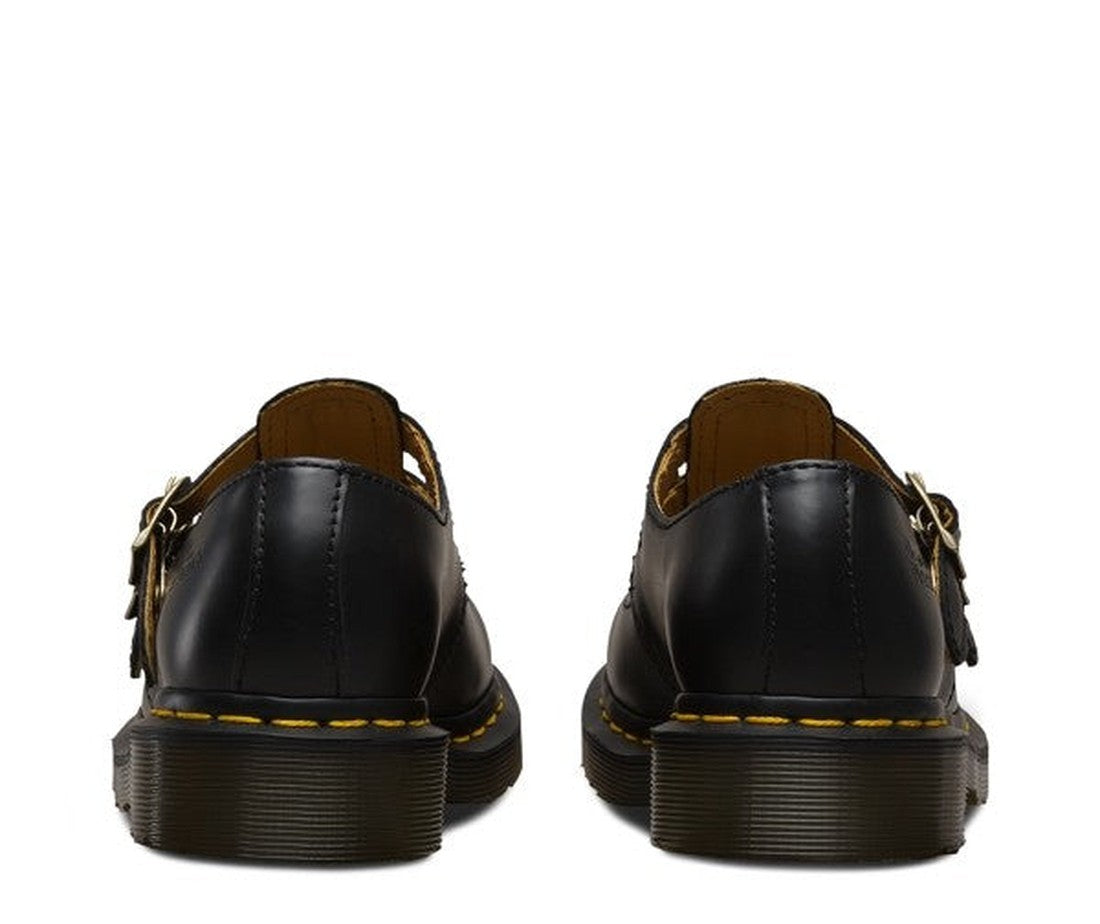 A close up of the heels of a pair of dr martens 8065 shoes in black smooth leather showing the slighty heel and yellow stitching around the soles. 883985051775,
883985051782,
883985051799,
883985051805,
883985051812,
883985982772,, 883985051768, 883985051