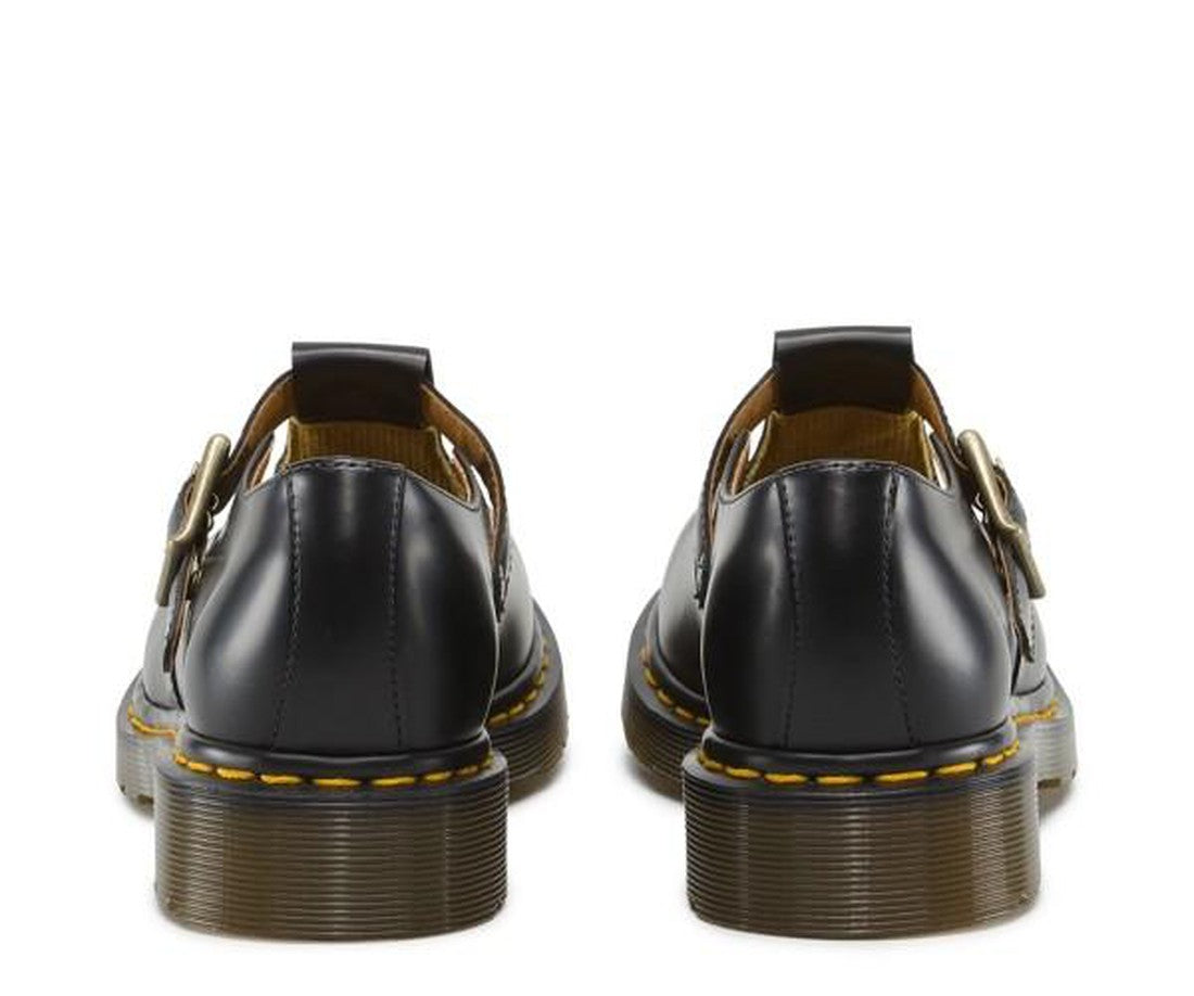 A picture showing the heel detailing and the over the foot strap of a pair of Dr Martens Polley Shoes T-Bar Mary Janes in Black leather., 883985498242,
883985498259,
883985498266,
883985498273,
883985498280,
883985498297,
883985498303,
883985498310,
, 883