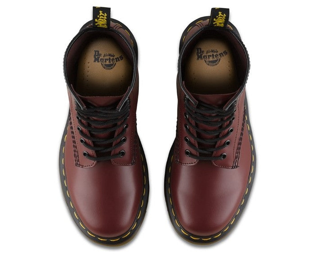 A pair of Dr Martens 1460 Cherry Red 1460Z DMC 8 Up Boot Smooth, seen from above, with smooth cherry red leather, black laces, yellow stitching on the sole, and heel loops featuring the brand logo., 800090827682, 800090827705, 800090827712, 800090827729, 