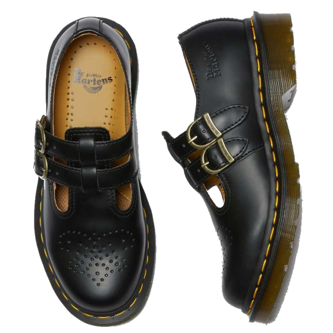 A pair of Dr Martens 8065 mary jane shes in balck . the right foot top down showing the partly punched detailing on the toe area and in yellow coloured insole. The left foot on it;s side showing the metal brass looking buckles  and the silloette of the so