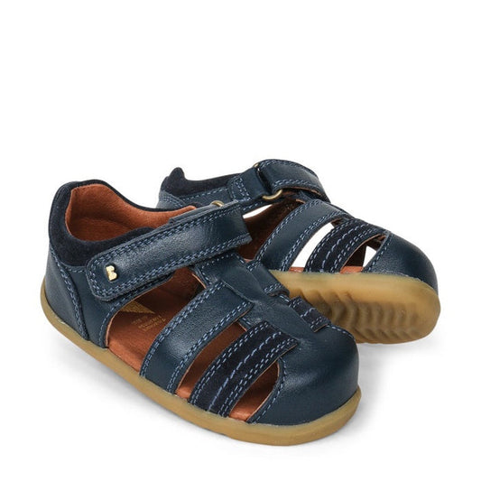 a pair of Bobux Step Up Sandal Roam 729201A Navy Closed Toe- closed toe sandals with closed back for heel support. velcro around the heel and straps of leather over the toes so air can move freely around the toes.