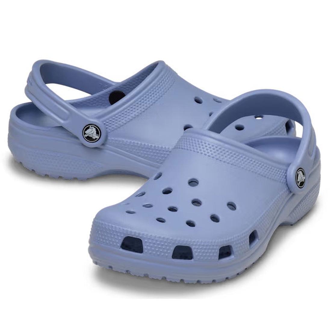 A pair of Crocs - Classic Clog Adults Blue Haze Sandals, unisex summer footwear with ventilation holes and adjustable heel straps, displayed against a white background.