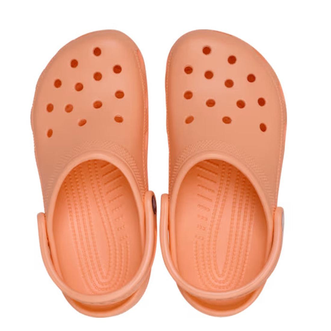 A pair of Crocs - Classic Clog Adults Sunstone Soft Orange with ventilation holes and adjustable heel straps, viewed from above on a white background., 47587, 198445262562, 198445262579, 198445262586, 47591, 47592, 47593, 47594, 47595
