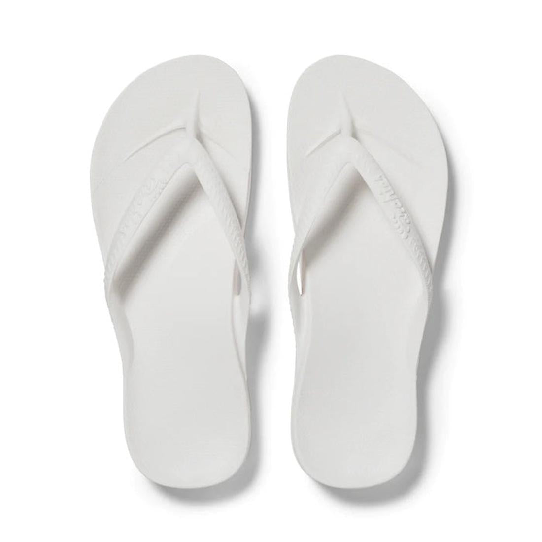 Archies Footwear's Archies Arch Support Jandal White—white sandals with comfy cushioned soles and secure textured straps, top view.  ksnz