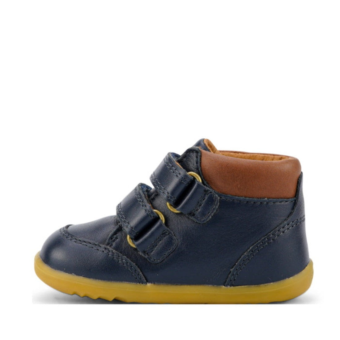 The Bobux Iwalk Timber Navy Leather Boot 632619 is a small dark blue premium full grain leather toddler shoe with two adjustable straps, brown padded ankle collar, yellow stitching, and yellow rubber sole, shown from the side on a white background., 94200