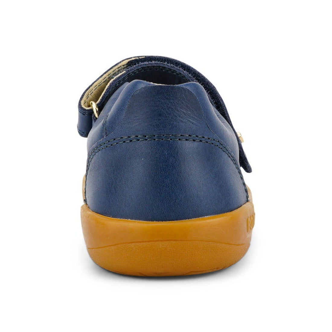 A close-up rear view of the Bobux Kid+ Delight Mary Jane Navy 831615Z girls’ leather shoe with a tan rubber sole and Velcro strap, styled in classic Mary Jane fashion, shown against a white background., 9420075721210, 9420075721227, 9420075721234, 9420075