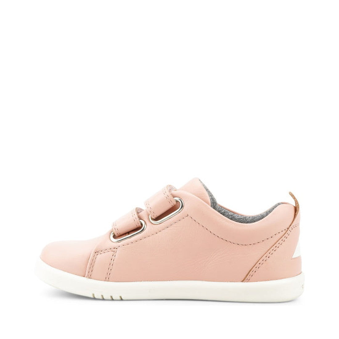 The Bobux KP Kid Plus Grass Court Seashell Pink 832448 is a light pink kids trainer with double velcro straps, white rubber sole, gray interior lining, and tan pull tab at the heel, shown in side profile on a white background., 9420075792579, 942007579304