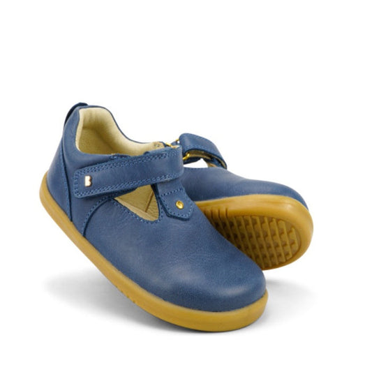 A pair of Bobux IW Iwalk Louise Midnight Blue 633030 children's shoes feature a leather upper, tan rubber soles, and a Velcro T Bar strap—one upright, one lying on its side.