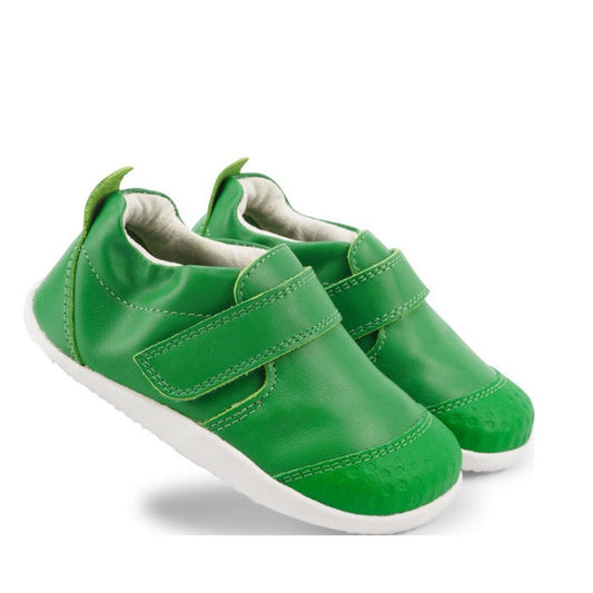 The Bobux Xplorer Go Emerald Green First Walker 501032 features bright green, soft leather-like shoes with white soles and Velcro straps, offering a flexible fit—perfect for first steps. Displayed on a white background.