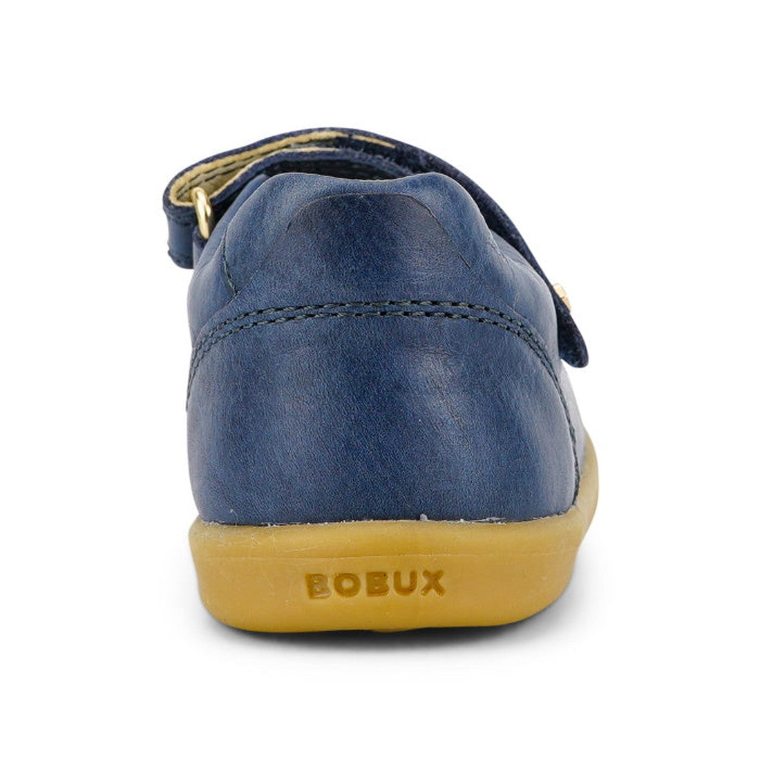 The Bobux Iwalk Delight Mary Jane Midnight Blue 628048 is a children’s shoe with blue leather, a tan rubber sole embossed with “BOBUX” on the heel, and a secure velcro strap over the upper, shown from the back., 9420068516748, 9420068516755, 9420068516762