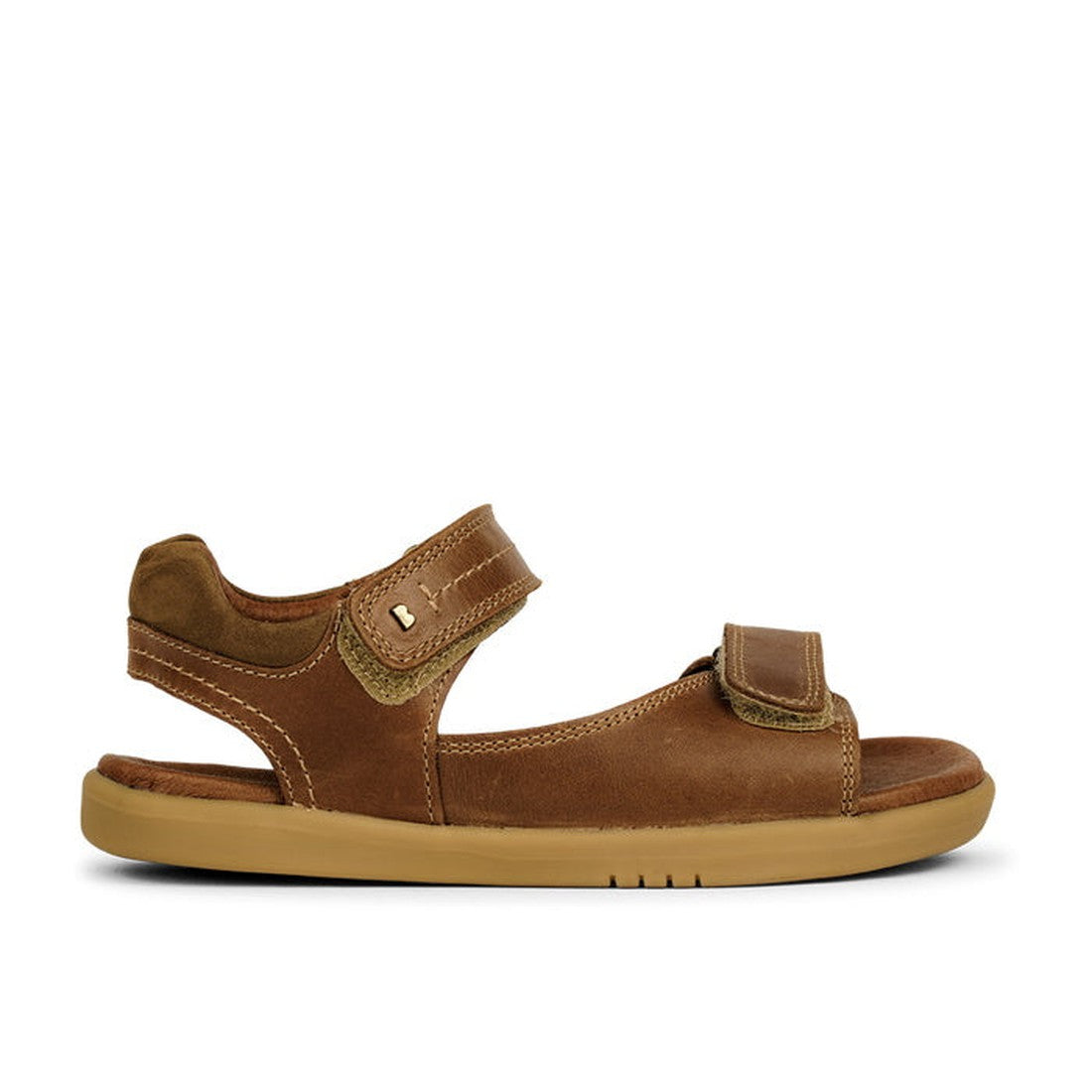 The Bobux Kid+ Plus Driftwood Caramel Open Toe Sandal 833504A features a brown leather upper, light tan sole, and adjustable double Velcro straps at the ankle and toes, shown in side profile against a white background., 9420062051078, 9420062051085, 94200