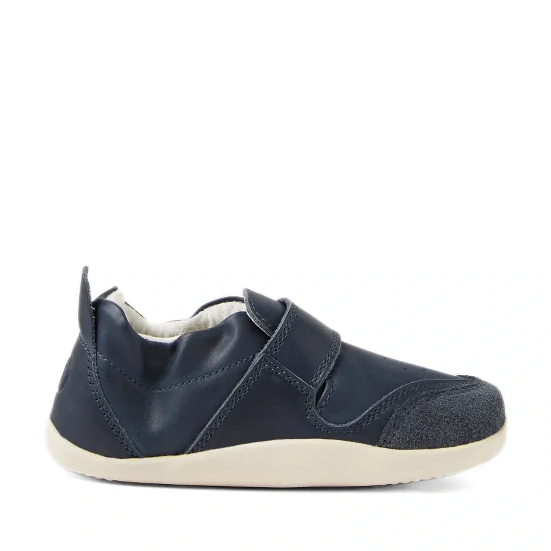 A single Bobux XP Explorer Ripple First Walker Navy 502509 shoe is displayed in a side view against a white background, featuring a navy blue slip-on design with a soft upper material, reinforced toe cap, and a flexible white sole., 42842, 9420068568563, 