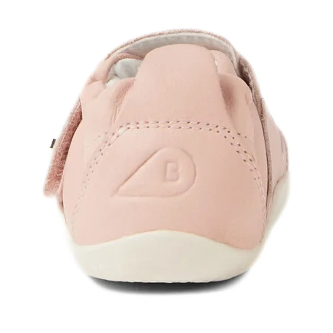 A rear view of the Bobux XP Explorer Ripple First Walker Cameo Rose 502603 showcases a soft pink baby shoe with a white sole and an embossed B logo on the heel, designed for growing toddlers with its flexible sole., 42846, 9420068568518, 9420068568525, 94