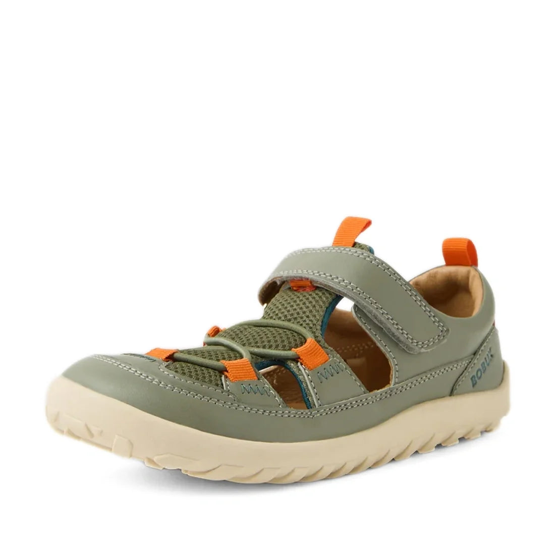 The Bobux Kid+ KP Rocky Leather Closed Toe Sandal in Vetiver Green is a kids’ sandal featuring a green and beige leather design with orange accents, breathable mesh panels, a Velcro strap for easy fastening, and a rugged sole—perfect for outdoor or casual