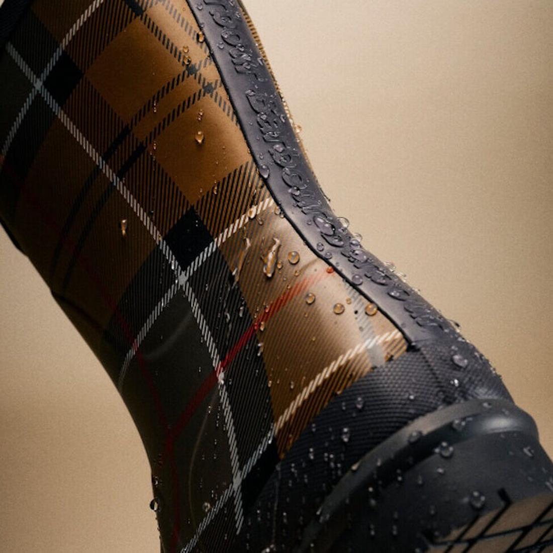 Close-up of Barbour Banbury Tartan Mid Calf Wellys Womens Rainboot featuring a brown, black, and white tartan pattern with water droplets on the surface, set against a neutral background., 5063669171042, 5063669171059, 5063669171066, 5063669171073, 506366