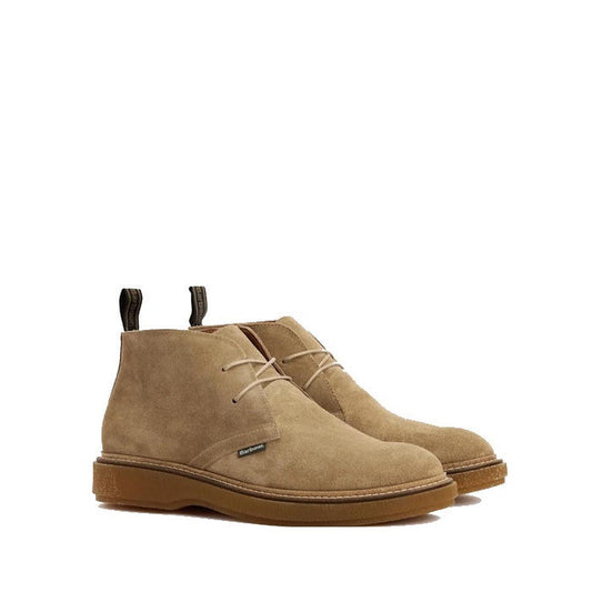Barbour Men's Blaine Chukka Lace Up Boot in taupe suede, featuring beige laces, dark pull tabs, light brown rubber soles, and premium Alaline leather. Shown on a white background.