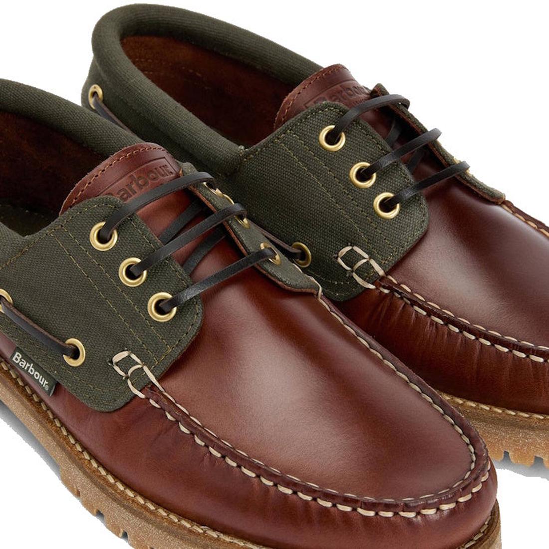 A close-up of Barbour Mens Re-Engineered Deck Boat Shoes Mahogany shows brown leather, green canvas, tan stitching, gold eyelets, black laces, Barbour logo tag on the side, and textured brown soles—versatile men’s casual footwear., 5020985780440, 50209857