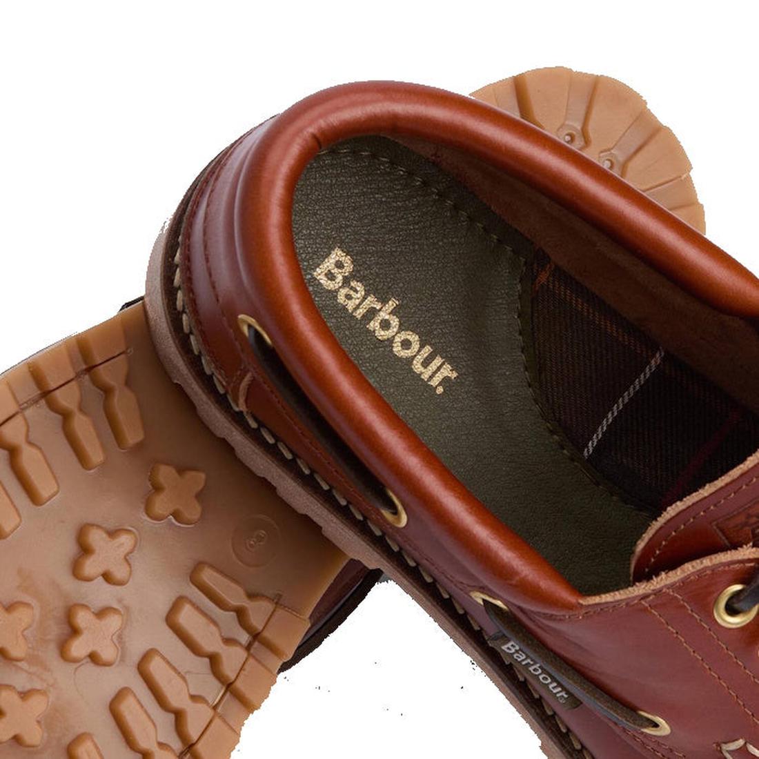 Close-up of Barbour Mens Re-Engineered Deck Boat Shoes Tan, showing brown uppers, tan rubber soles with cross-shaped treads and a sneaker-style design, plus the gold Barbour logo on the insole., 5020985782178, 5020985782659, 5020985783274, 5020985779802, 
