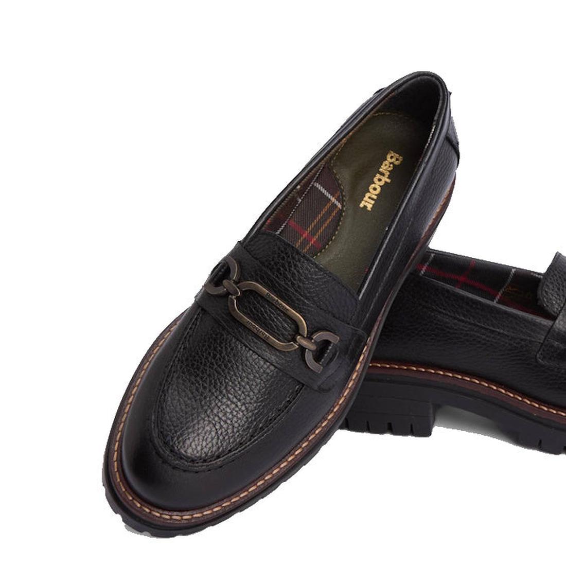 The Barbour Maddie Black Leather Womens Chunky Loafer features a chunky sole, decorative metal bit, plaid lining, and the Badbouu logo on the insole.