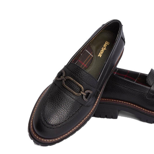 The Barbour Maddie Black Leather Womens Chunky Loafer features a chunky sole, decorative metal bit, plaid lining, and the Badbouu logo on the insole.