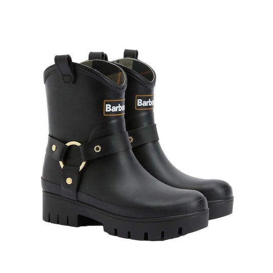 The Barbour Elley Harness Black Wellington Womens Rainboot features chunky soles, gold hardware, a front Barbour logo, and decorative ankle straps with buckles in durable black rubber.