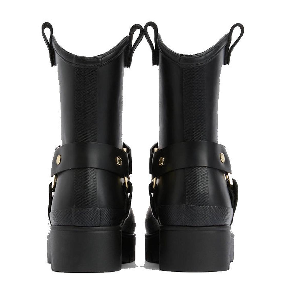 A pair of black Barbour Elley Harness Wellington womens rainboots shown from the back, featuring chunky heels, pull tabs, and gold-tone hardware straps—a modern twist on classic black rubber boots., 5020985983018, 5020985983575, 5020985984107, 50209859845