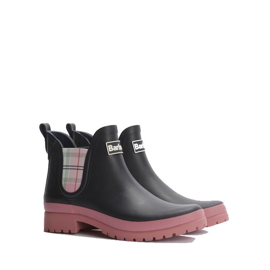 A pair of Barbour Mallow Navy Cherry Blossom Chelsea Women's Wellington Rainboots featuring black uppers, pink soles, pastel plaid elastic side panels, pull tabs, and a front branded label. Weatherproof design for rainy days.