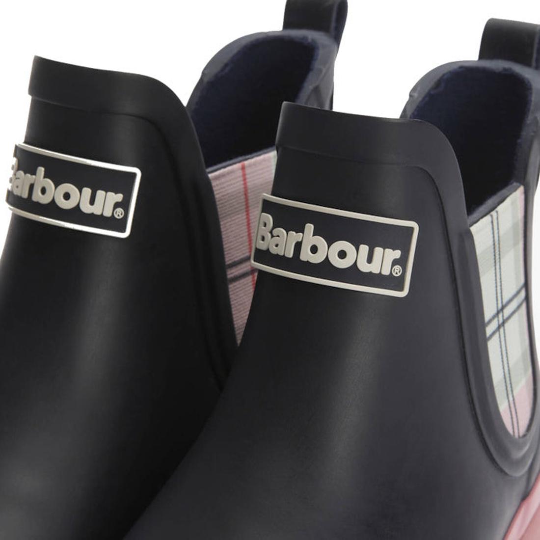 Close-up of two Barbour Mallow Navy Cherry Blossom Chelsea Women's Wellington Rainboots. The boots have black uppers, white logo labels, and plaid side panels in light pink and blue for added style to these weatherproof essentials., 5063669170908, 5063669