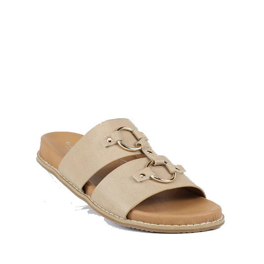 The Bay Lane Zuma Latte Beige Womens Leather Sandal features two wide straps with gold horsebit details, a cushioned footbed, flat sole, and visible edge stitching for both comfort and style.
