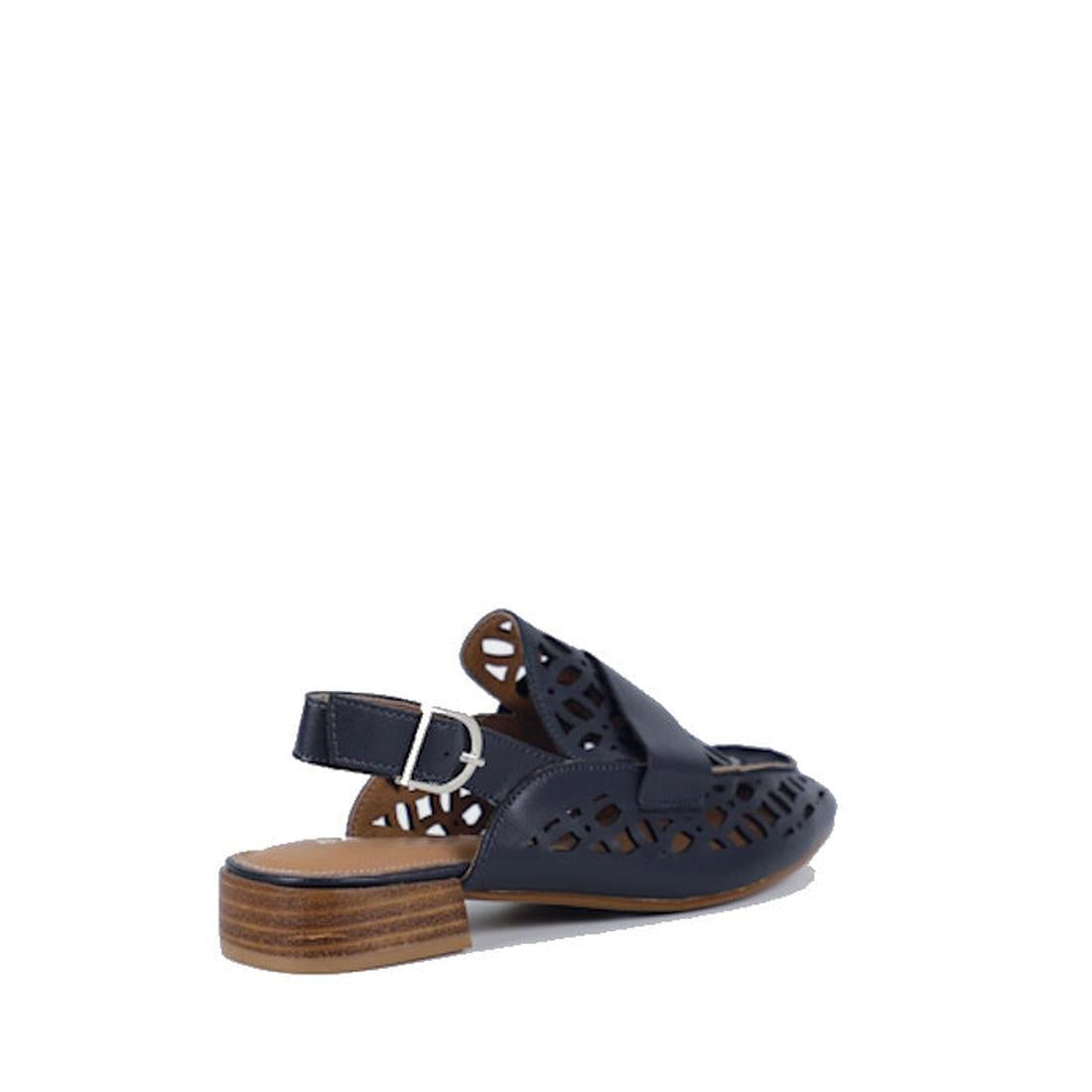 The Bay Lane Prima Navy Leather Womens Sling Back Sandal features a dark blue design with an open back, low wooden heel, cushioned footbed, cut-out patterns, and a silver buckle strap against a white background., 9357649062700, 9357649062717, 935764906272